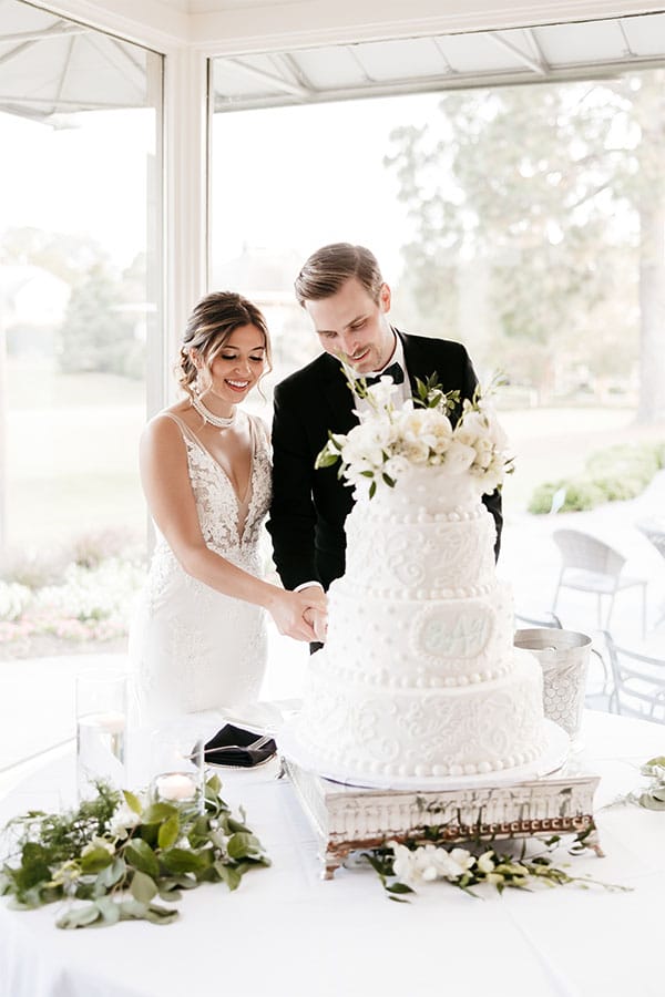 The bride and groom cutting their wedding cake.