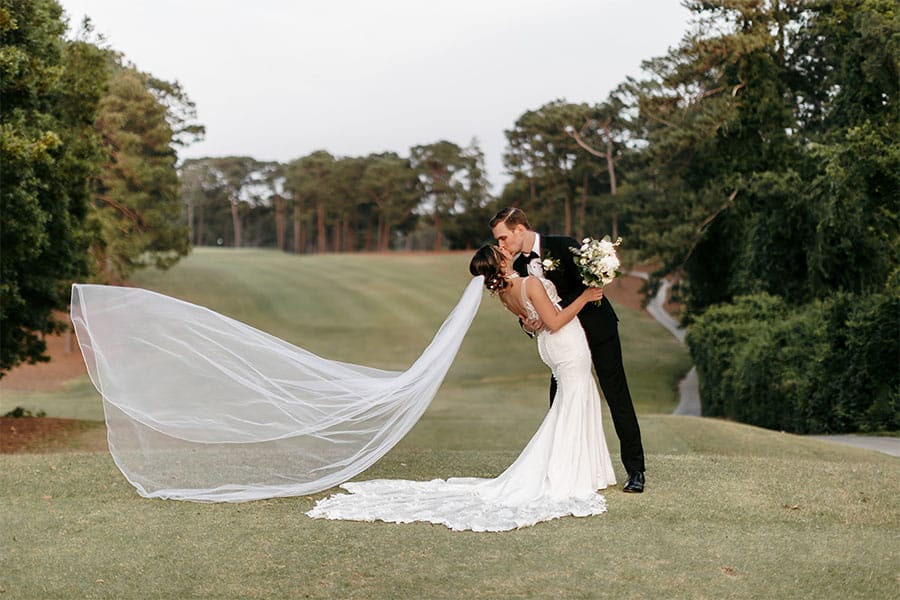 The bride and groom kissing.