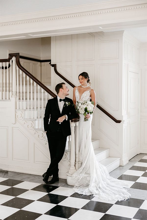 The bride and groom on a staircase.