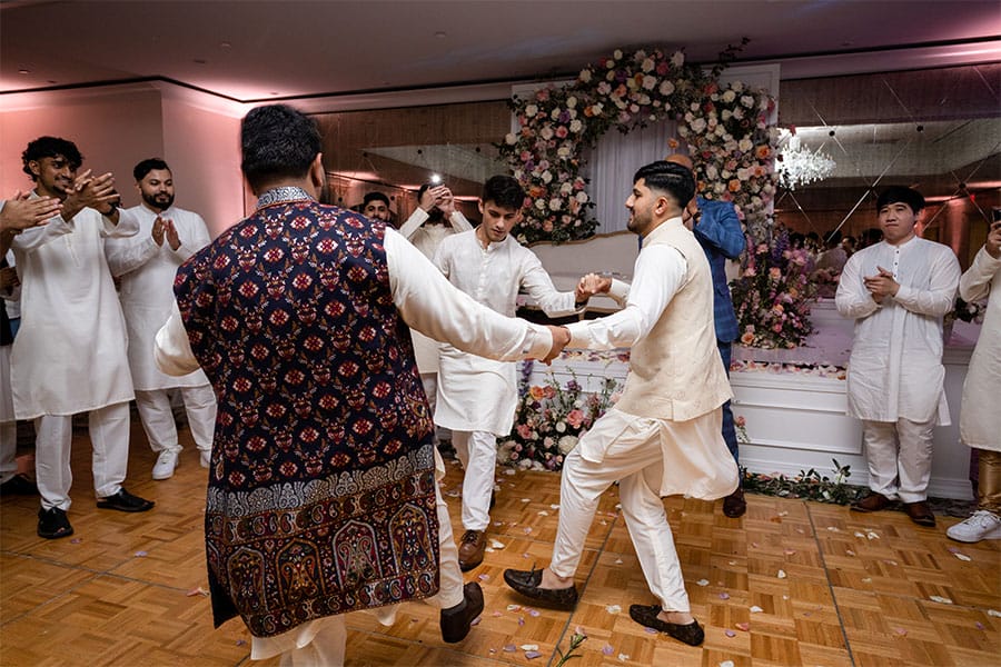 Men dancing at the wedding.