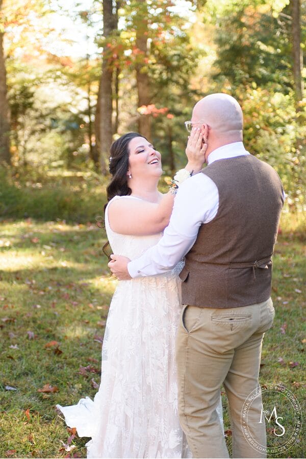 The bride and groom in front of beautiful woods.