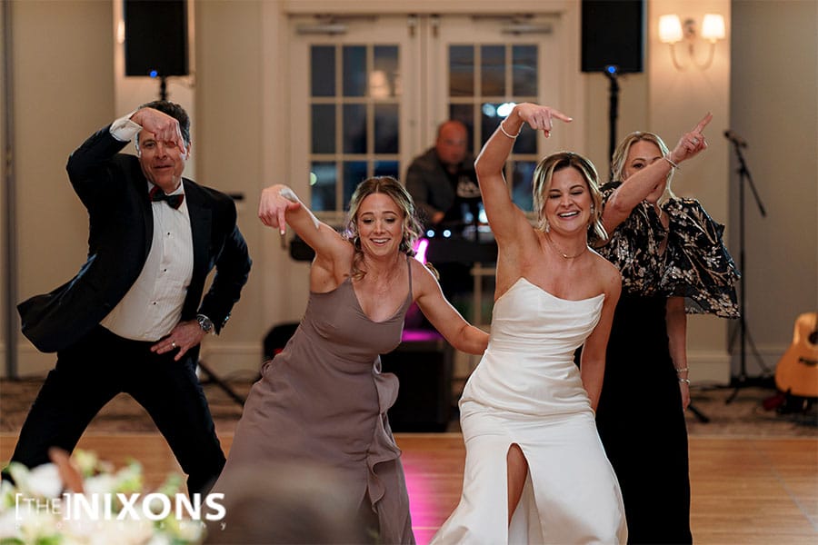 The bride dancing with family and friends.