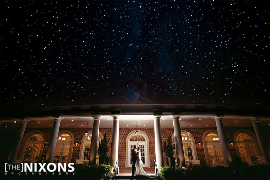 The bride and groom in front of the wedding venue.