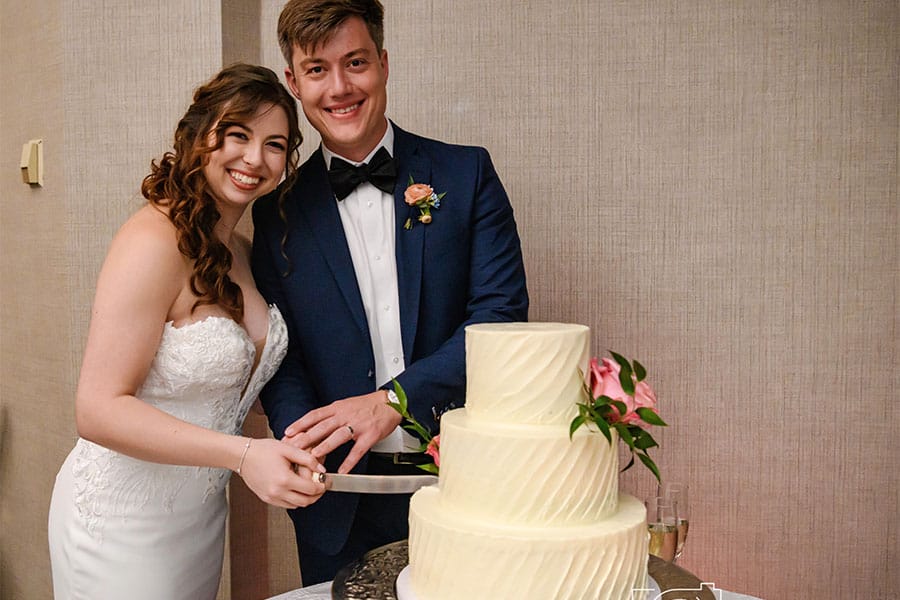 The bride and groom cutting there cake.