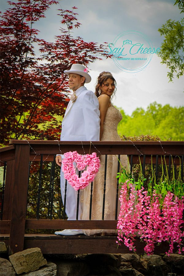 The bride and groom on a bridge.