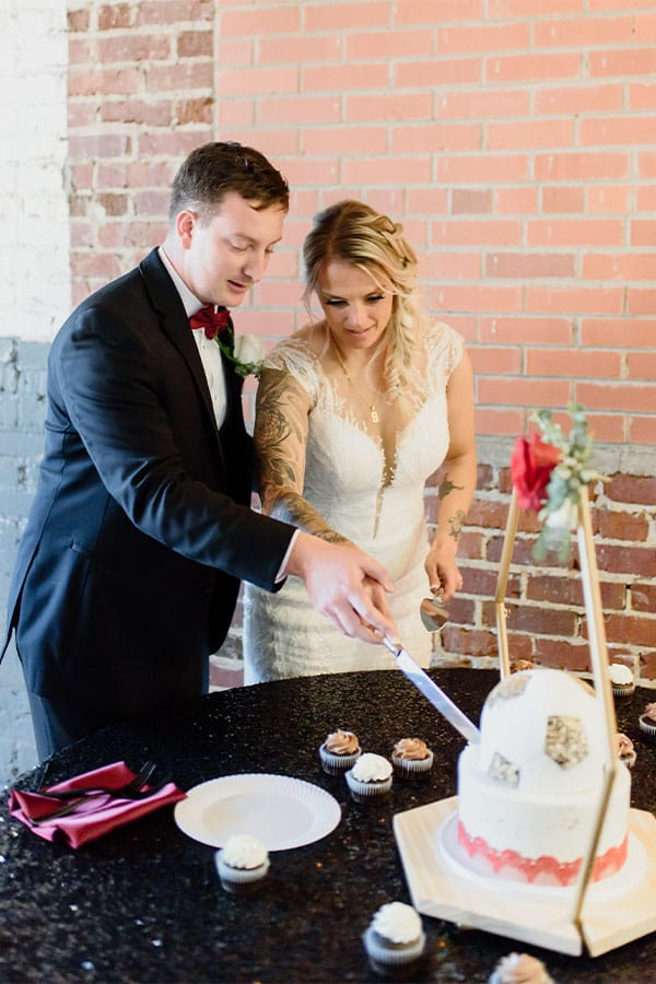 The bride and groom cutting the cake.