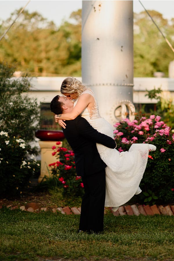 The bride and groom kissing.