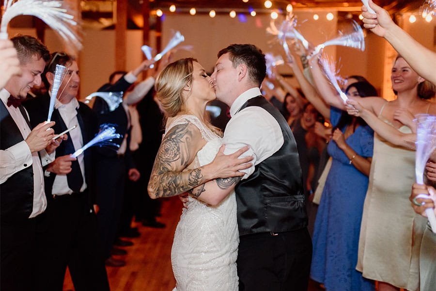 The bride and groom kissing.