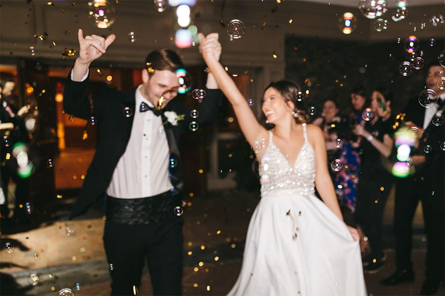 The bride and groom leaving with bubble around them.