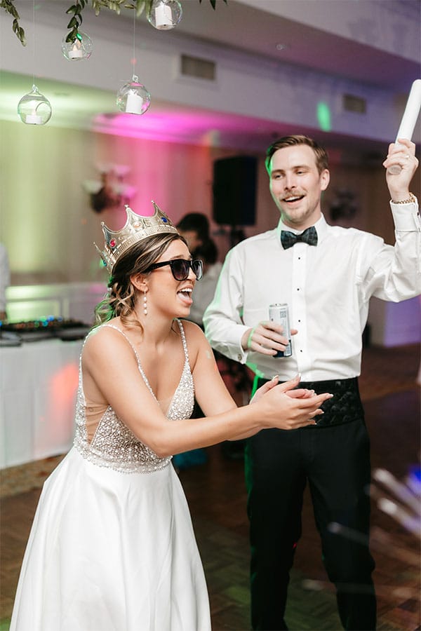 The bride and groom celebrating thier wedding by dancing and having fun.