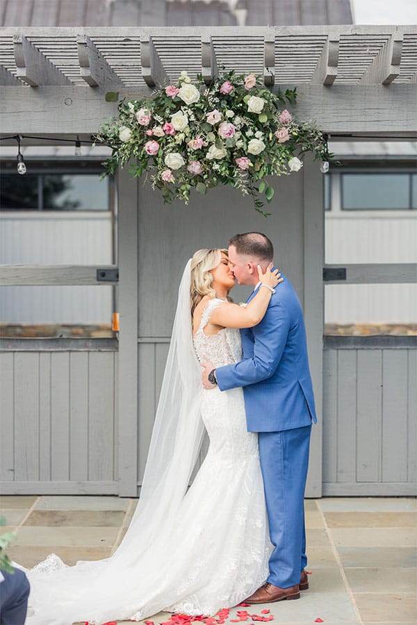 The bride and groom kissing.
