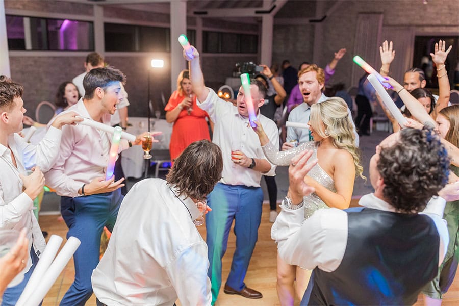 The bride and grooms friends and family dancing.