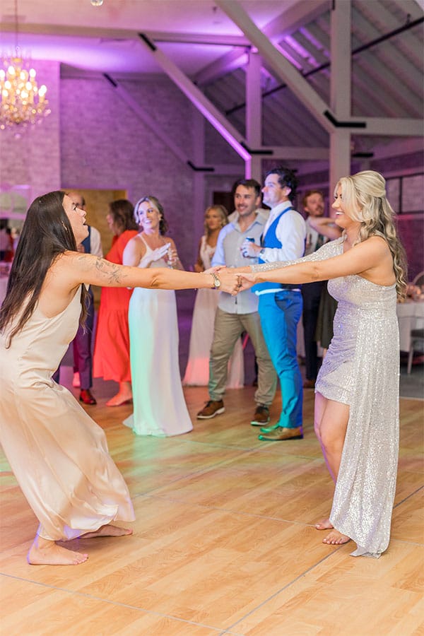 The bride and grooms friends and family dancing.