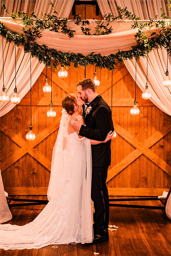 The bride and groom kissing.
