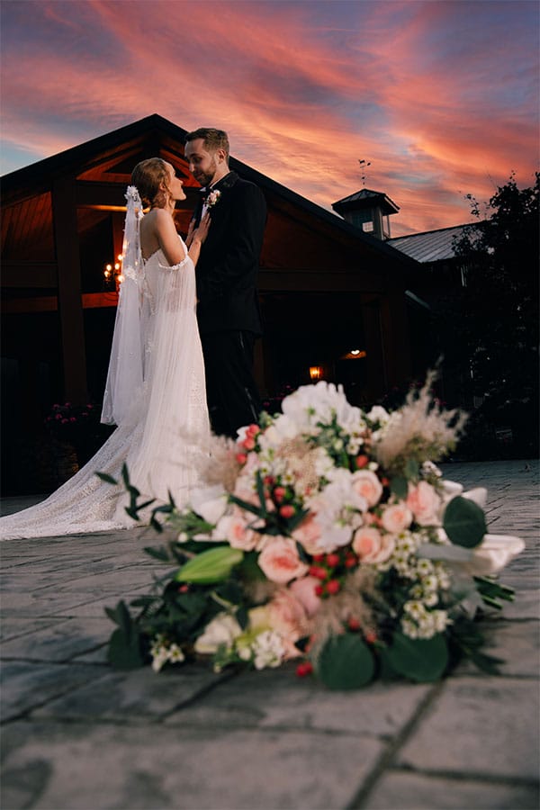 The bride and groom looking at eachother with a beautiful sunset in the background.