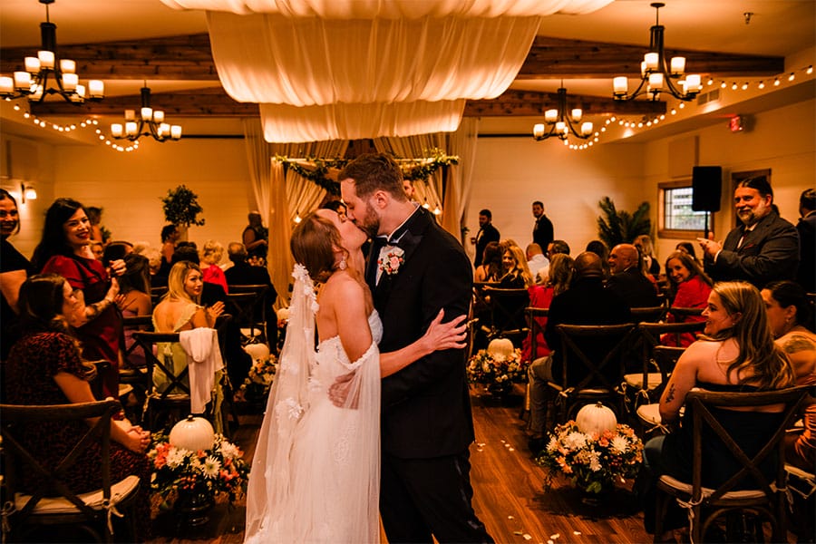 The bride and groom kissing.