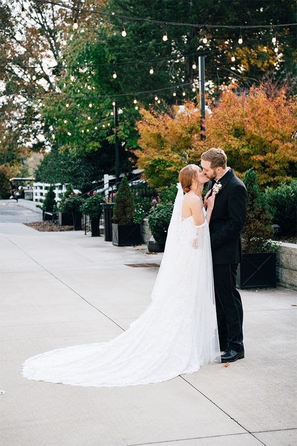 The bride and groom kissing.