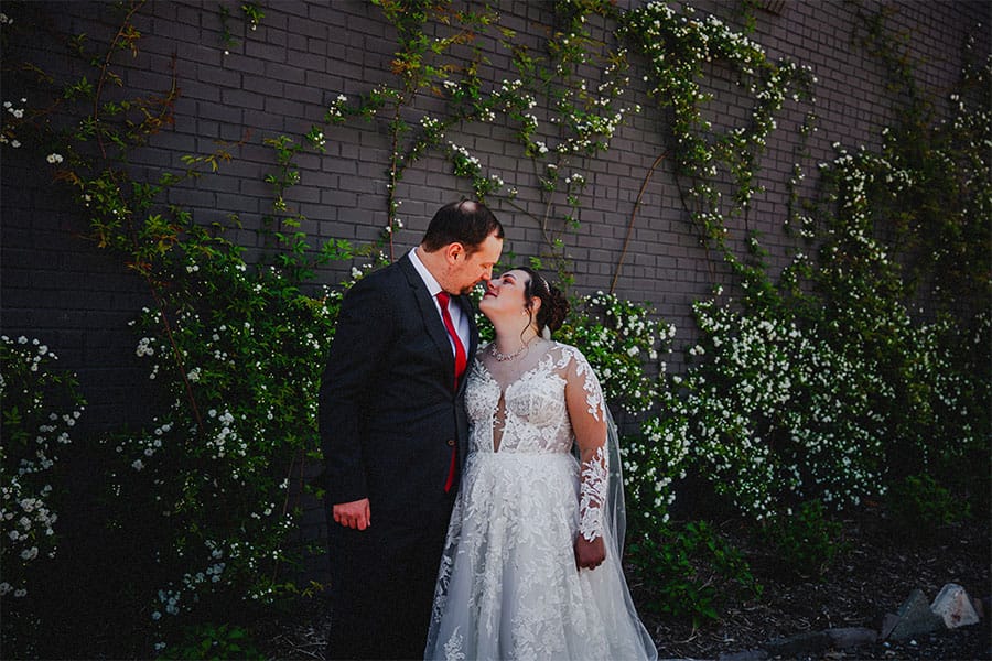 The bride and groom kissing.