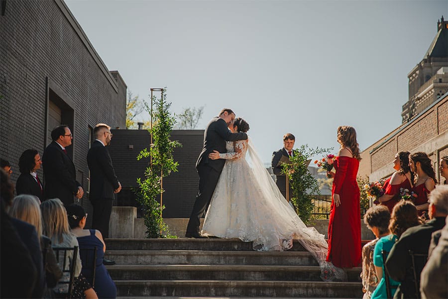 The bride and groom kissing at the alter.