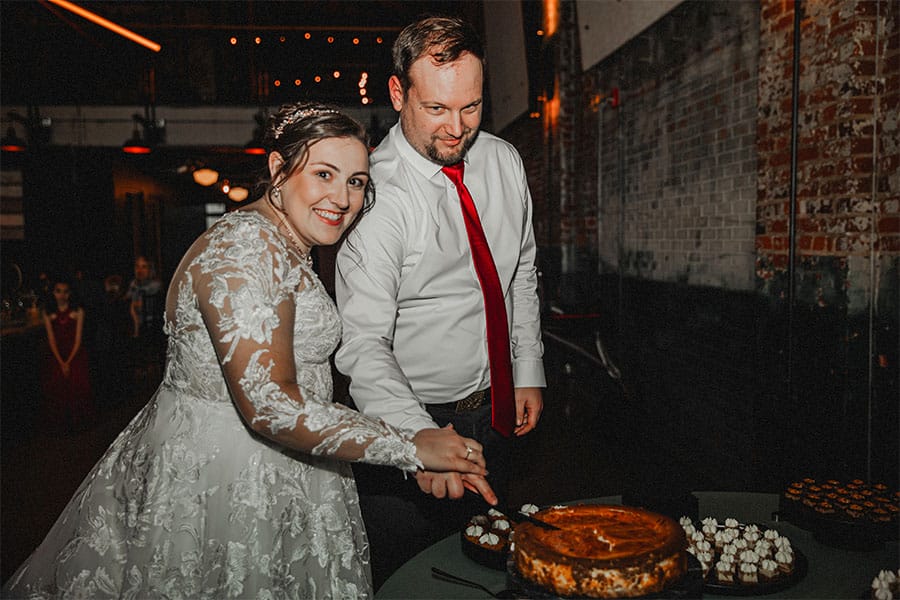 The bride and groom cutting their cake.