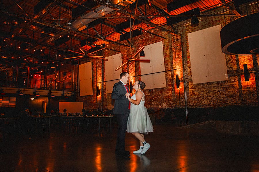 The bride and groom dancing alone together.