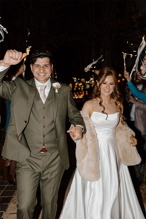 The bride and groom leaving their wedding venue.
