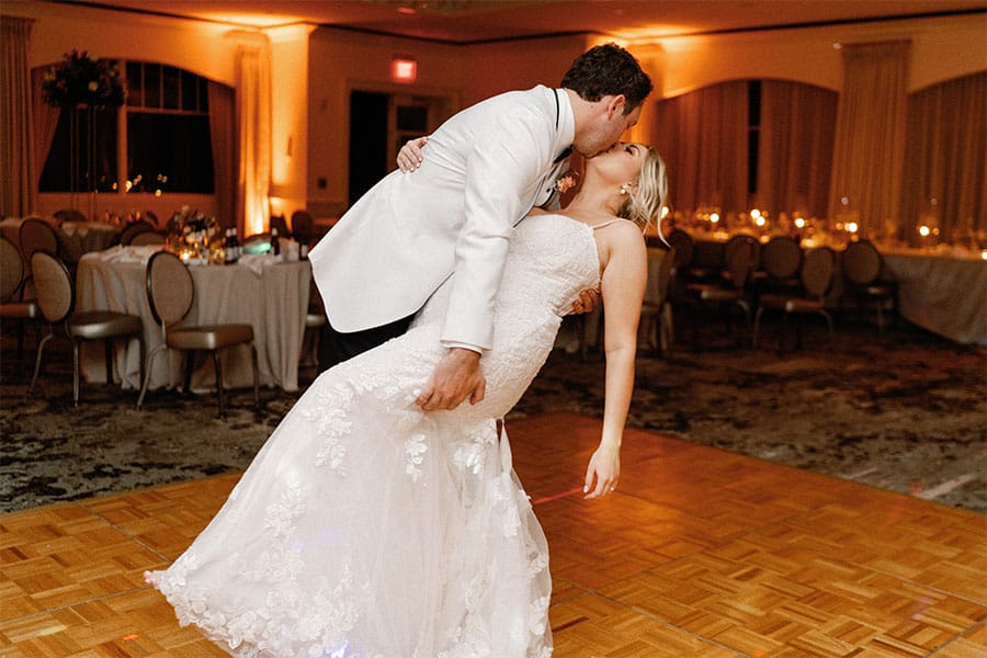 The bride and groom kissing.