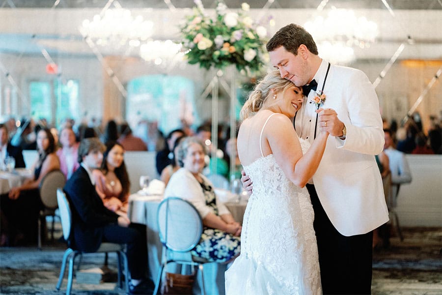The bride and groom dancing together.