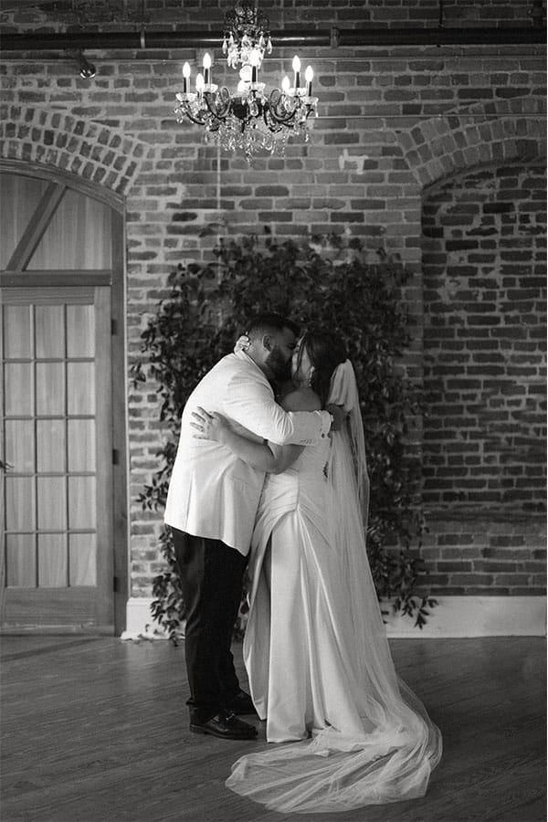 The bride and groom kissing.