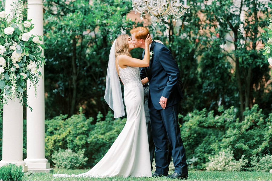 The bride and groom kissing.