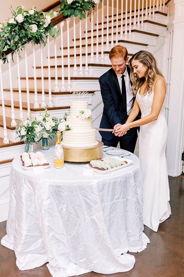 The bride and groom cutting their wedding cake.