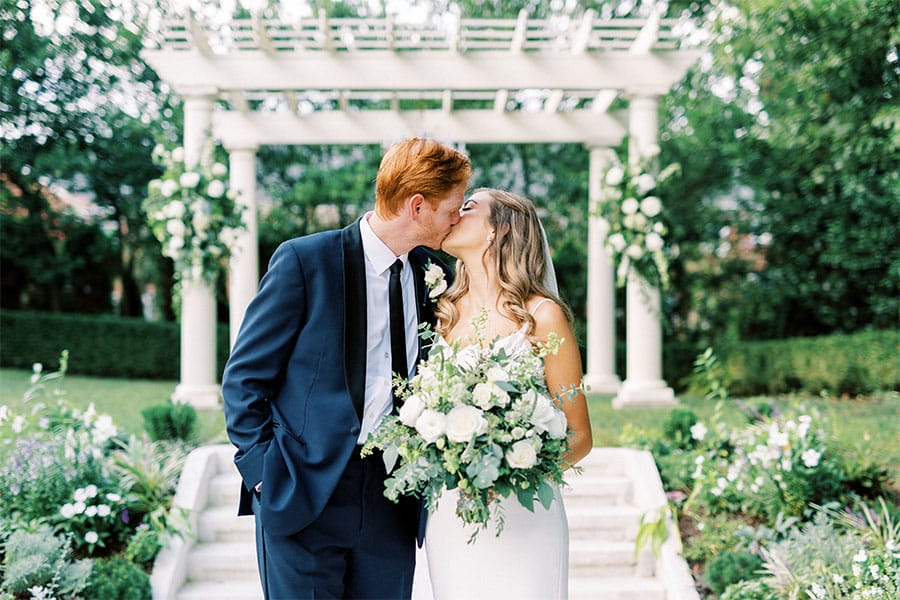 The bride and groom kissing.