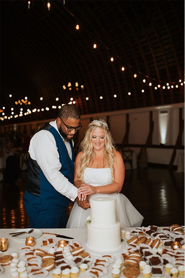 The couple cutting their wedding cake.