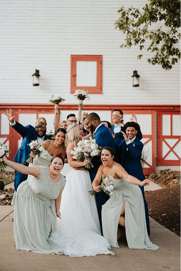 The couple with their bridesmaids and groomsmen around them.