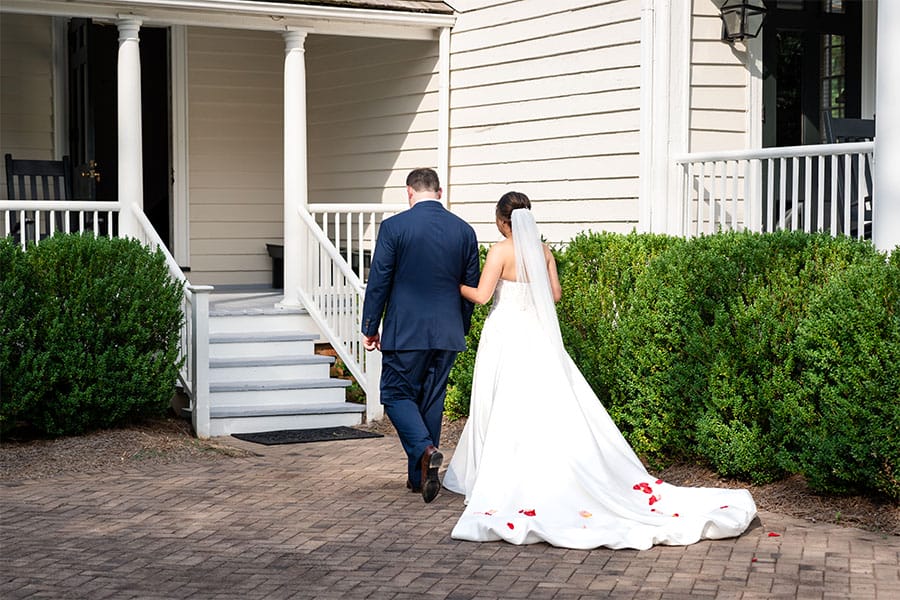 The bride and groom walking up stairs.